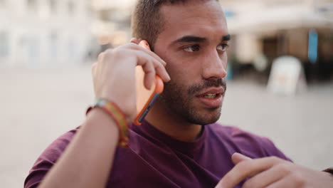 young man having a call sitting in a cafe.