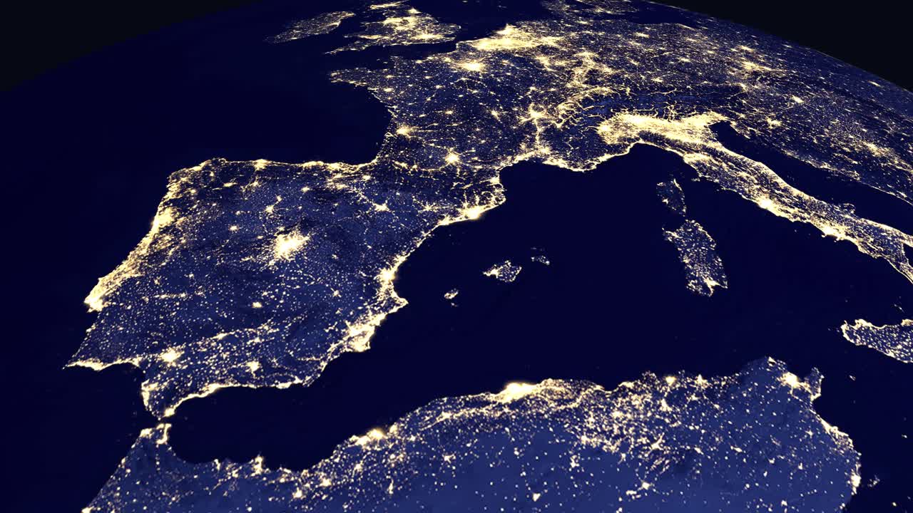 Digital globe rotates and zooms into a nighttime view of Madrid Spain with city labels