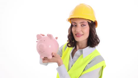 female construction worker or engineer holding a piggy bank, symbolizing savings and financial planning