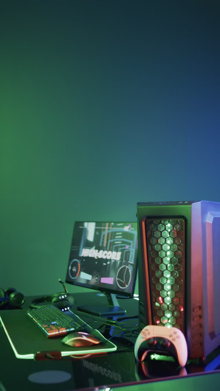 Vertical video of video game computer equipment on green neon background