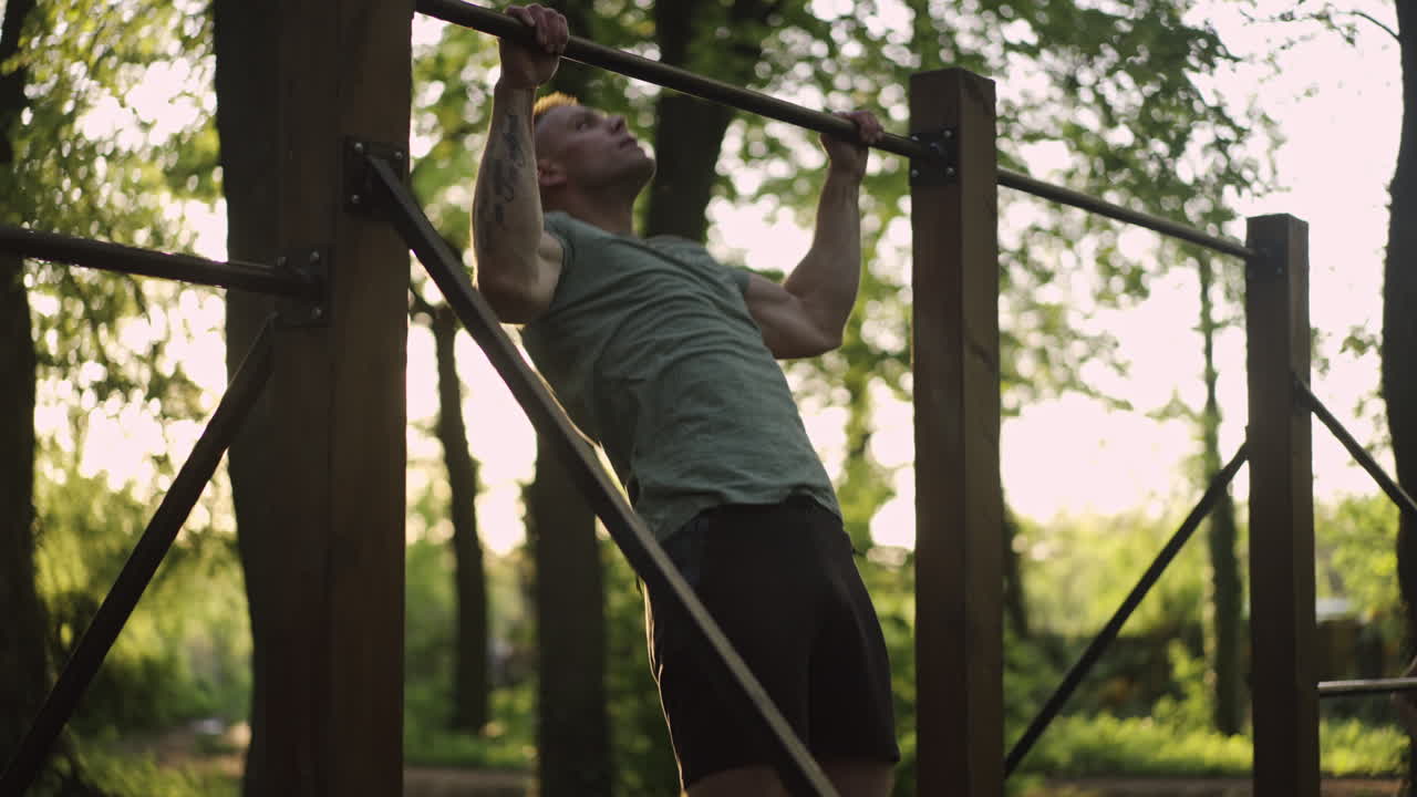 Man doing pull-ups in the park
