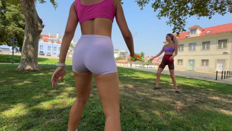 women playing tennis in the park on a sunny day