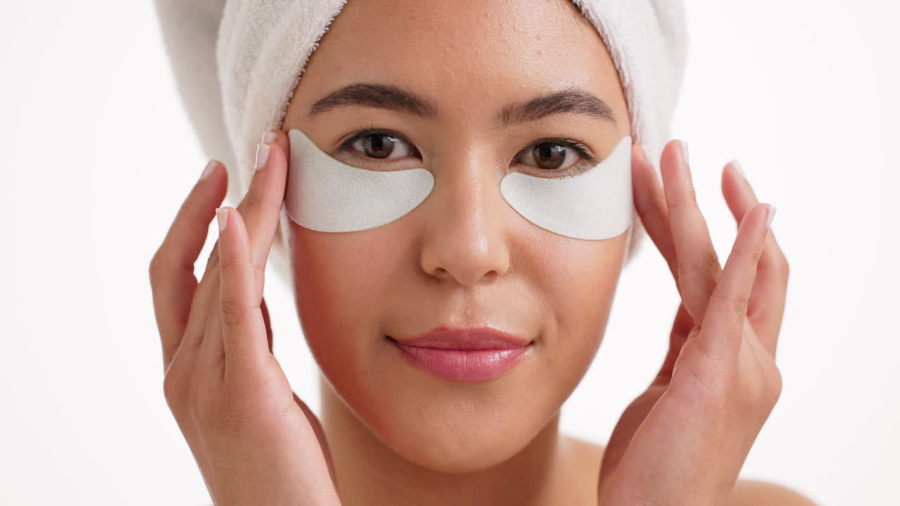 Woman applying eye patches for skincare