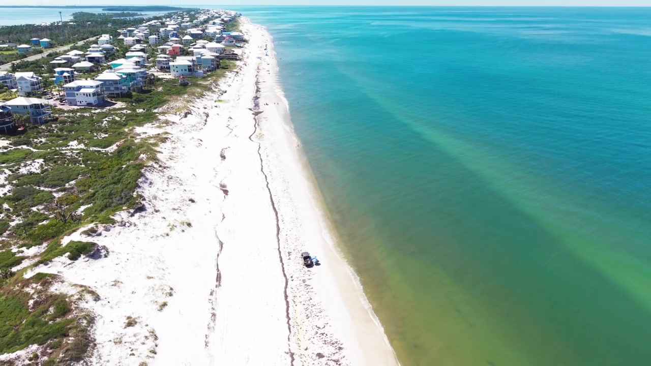 Flygvy i omloppsbana över den orörda vita sandstranden vid Cape San Blas kustlinje på en barriärö som sträcker sig längs turkosa vatten i Mexikanska golfen, Florida, USA.
