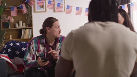 Friends-At-Home-Celebrating-With-Party-For-American-Independence-Day-4th-July-Taking-Selfie-On-Mobile-Phone-1