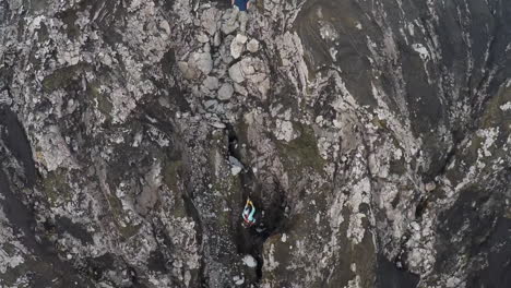 Aerial-over-mountain-climbers-on-a-steep-cliff