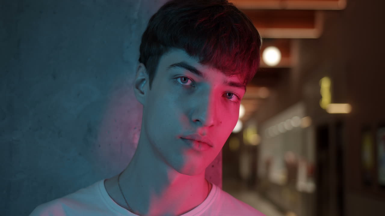 Portrait of a young man with blue and red lighting