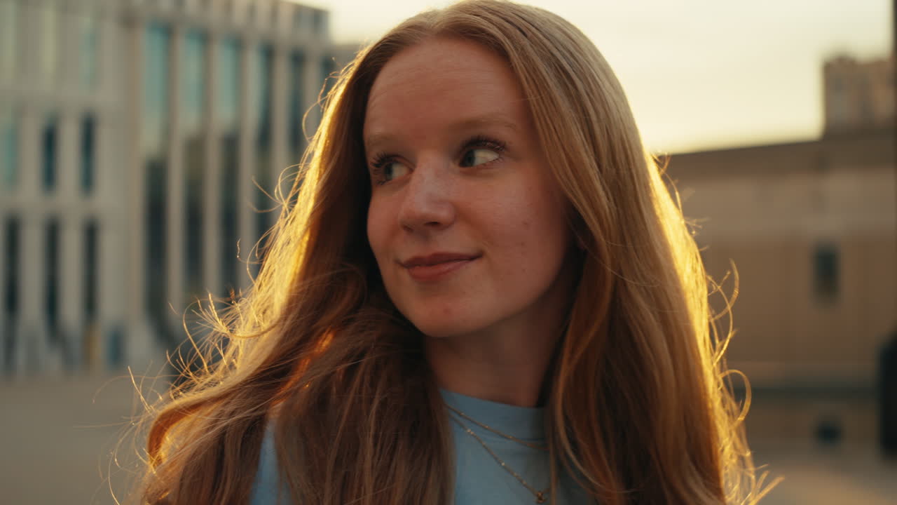Portrait of a woman with red hair at sunset