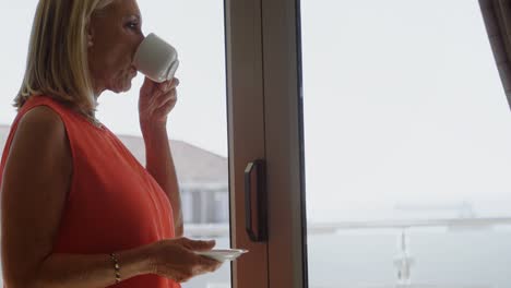 Disabled-woman-having-coffee-near-window-4k
