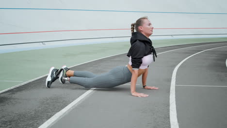 sportswoman exercising on track