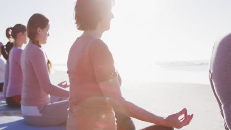 Multiethnische-Gruppe-Von-Frauen,-Die-Yoga-Position-Am-Strand-Und-Im-Hintergrund-Des-Blauen-Himmels-Machen