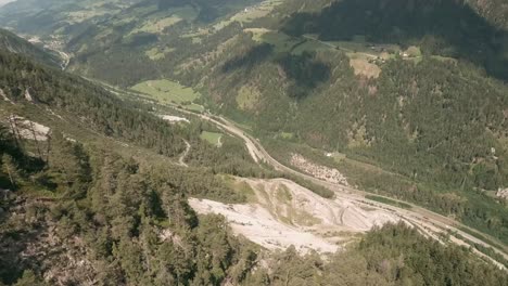 Action-camera-footage-from-FPV-racing-drone-flying-fast-and-very-close-down-a-mountain-in-Austria-in-summer