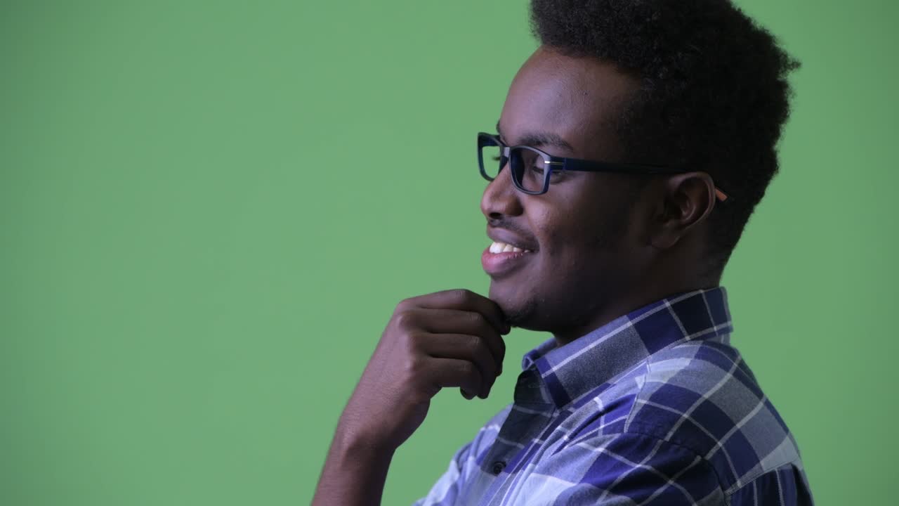 Young African hipster man with Afro hair wearing eyeglasses