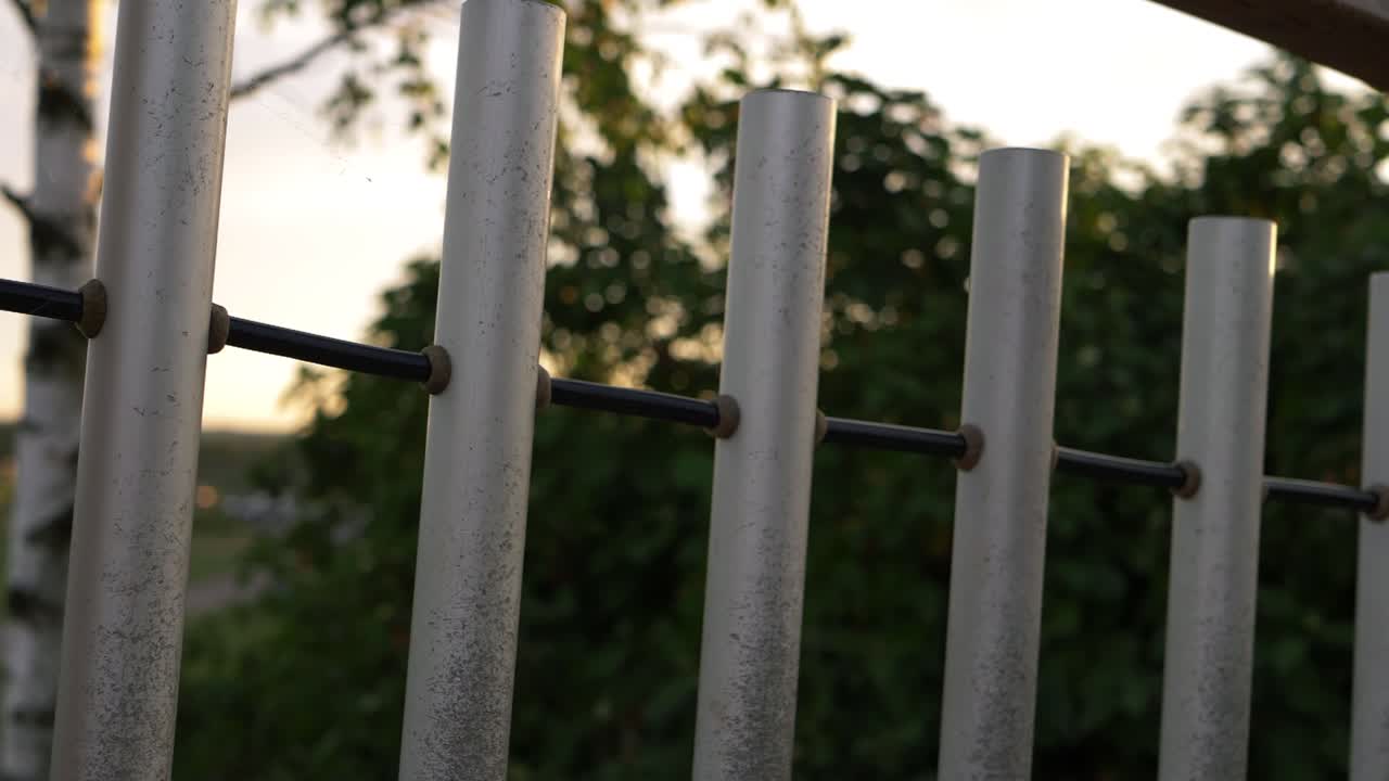Metal tube fencing panning shot
