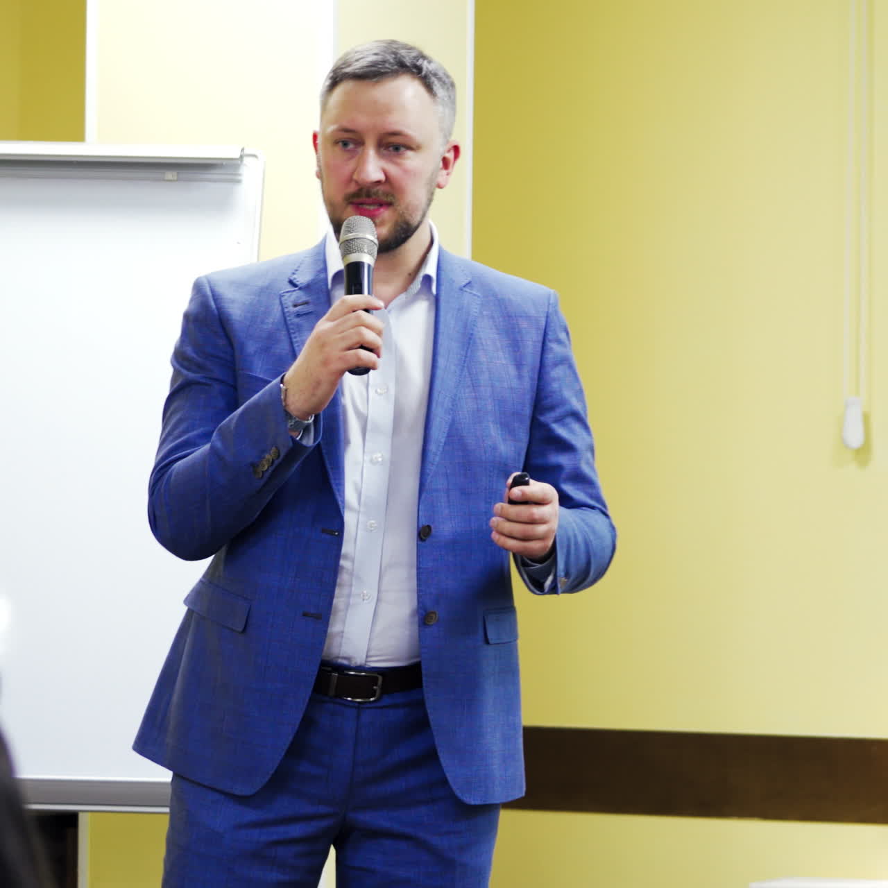 Young businessman at business conference room with public giving presentations. Audience at the conference hall. Entrepreneurship club.