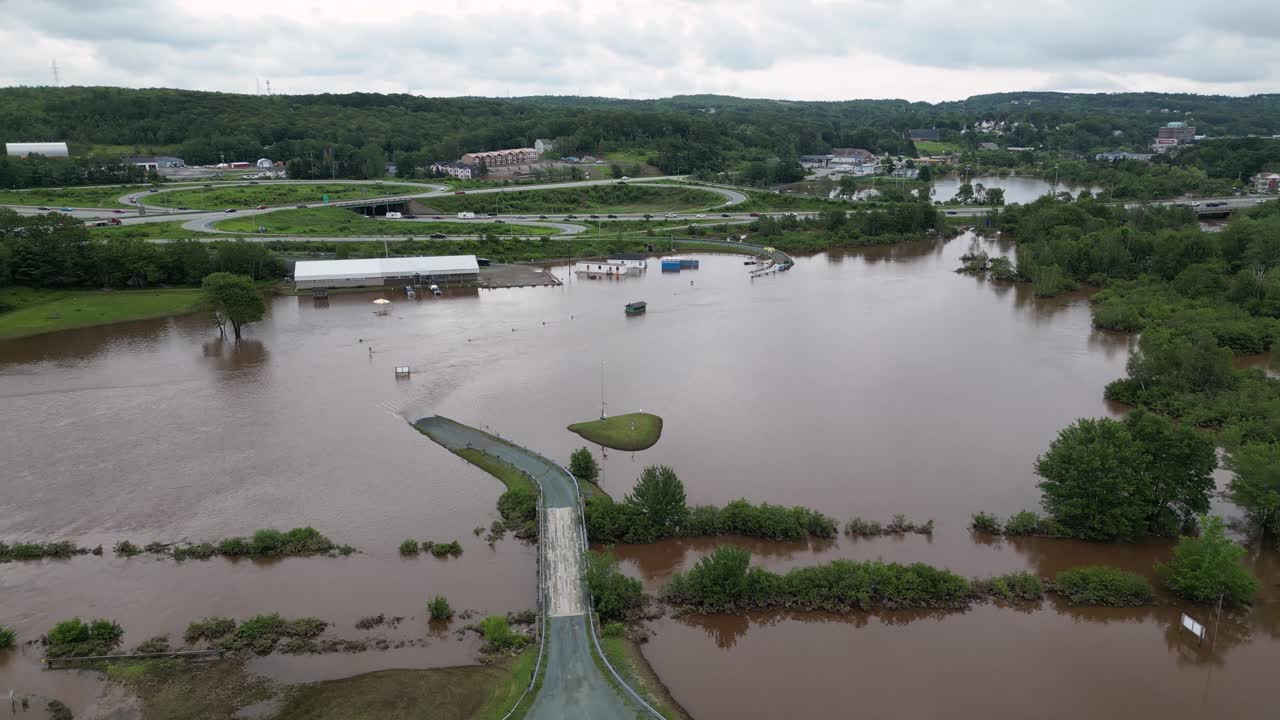 Flooded agricultural farm land after climate change disaster overflows river