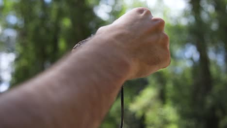 shot of someone pulling off a gooey golden brown marshmallow off of a metal skewer to make s'mores