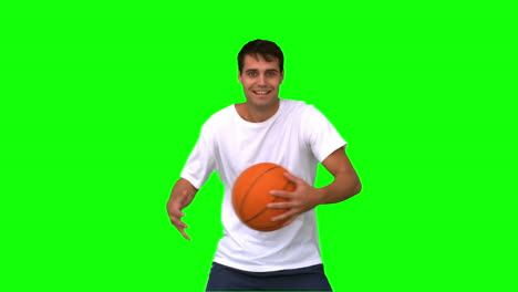 Man-playing-and-dribbling-with-a-basketball-on-green-screen