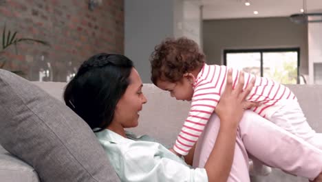 Mother-holding-her-baby-on-her-knees-