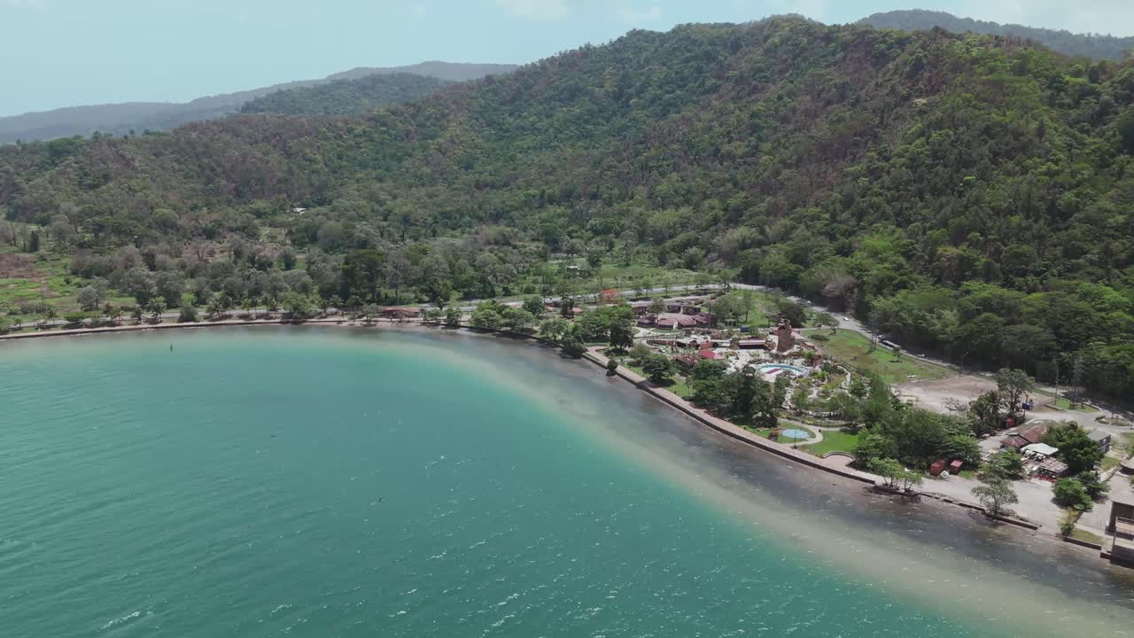 An aerial drone perspective showcases the Chaguaramas boardwalk and Williams Bay on the Caribbean island of Trinidad.