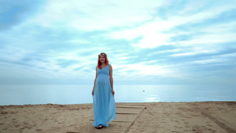 pregnant woman walking on beach at morning. woman pregnant