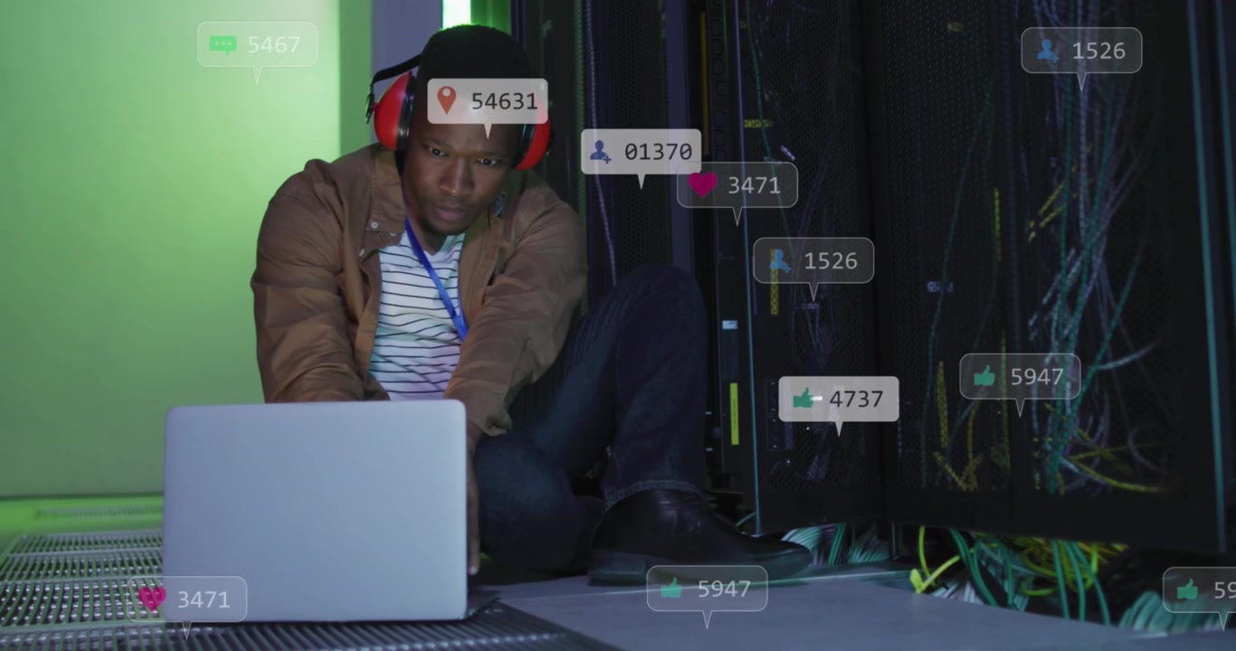 Animation of social media icons over african american male engineer using laptop at server room