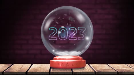 Animation-of-christmas-snow-globe-with-snow-falling-and-2023-text-on-brick-background