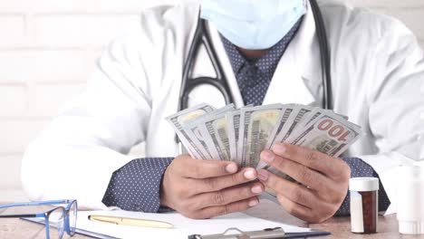 doctor holding money