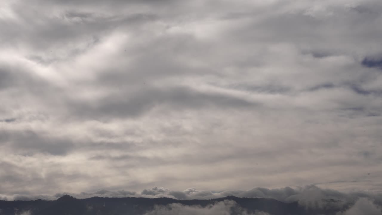 Fog and mist create a soft cinematic texture over mountain landscape ideal for editing use