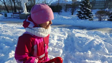 Side-view-little-girl-running-in-winter-park.-Sunny-winter-day