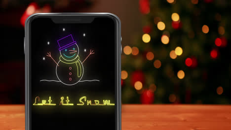 Animation-of-let-it-snow-text-and-snowman-in-smartphone-over-christmas-tree