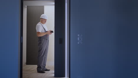 Zoom-camera.-Man-electrician-checks-the-voltage-in-the-network-with-a-wire-tester-preparing-to-install-a-smart-home