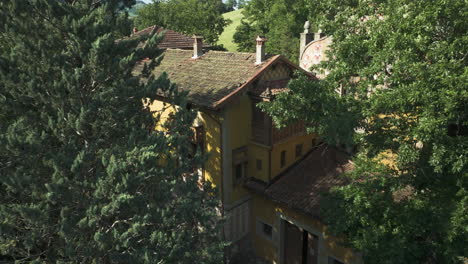 abandoned yellow villa surrounded by trees in italy, hidden in a lush forest