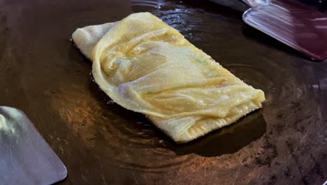 cooking roti or flatbread on a griddle