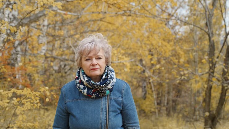Senior woman in autumn park
