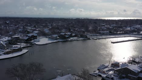 a drone view high over bay shore, ny, on a bright day after a recent snowfall