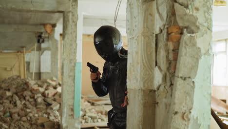 fighter looks behind broken brick wall hiding from bad guys