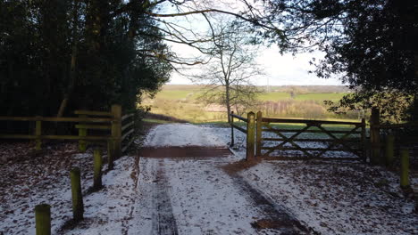 A-farm-track-leading-through-a-farm-gate-opens-up-to-spectacular-views-of-the-Worcestershire-Countryside,-England,-UK-on-a-cold-winters-day