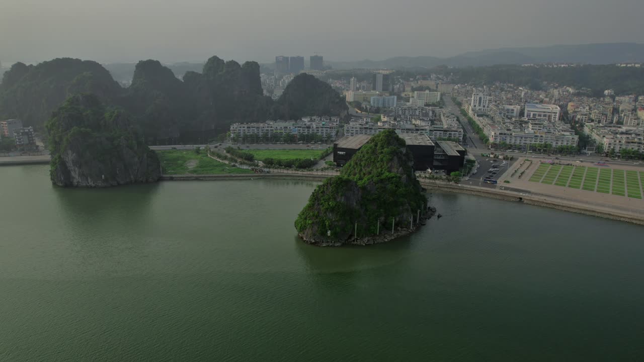 Aerial view of Ha Long Town, showcasing the coastal buildings on a gloomy day, with the cityscape stretching along the shore.