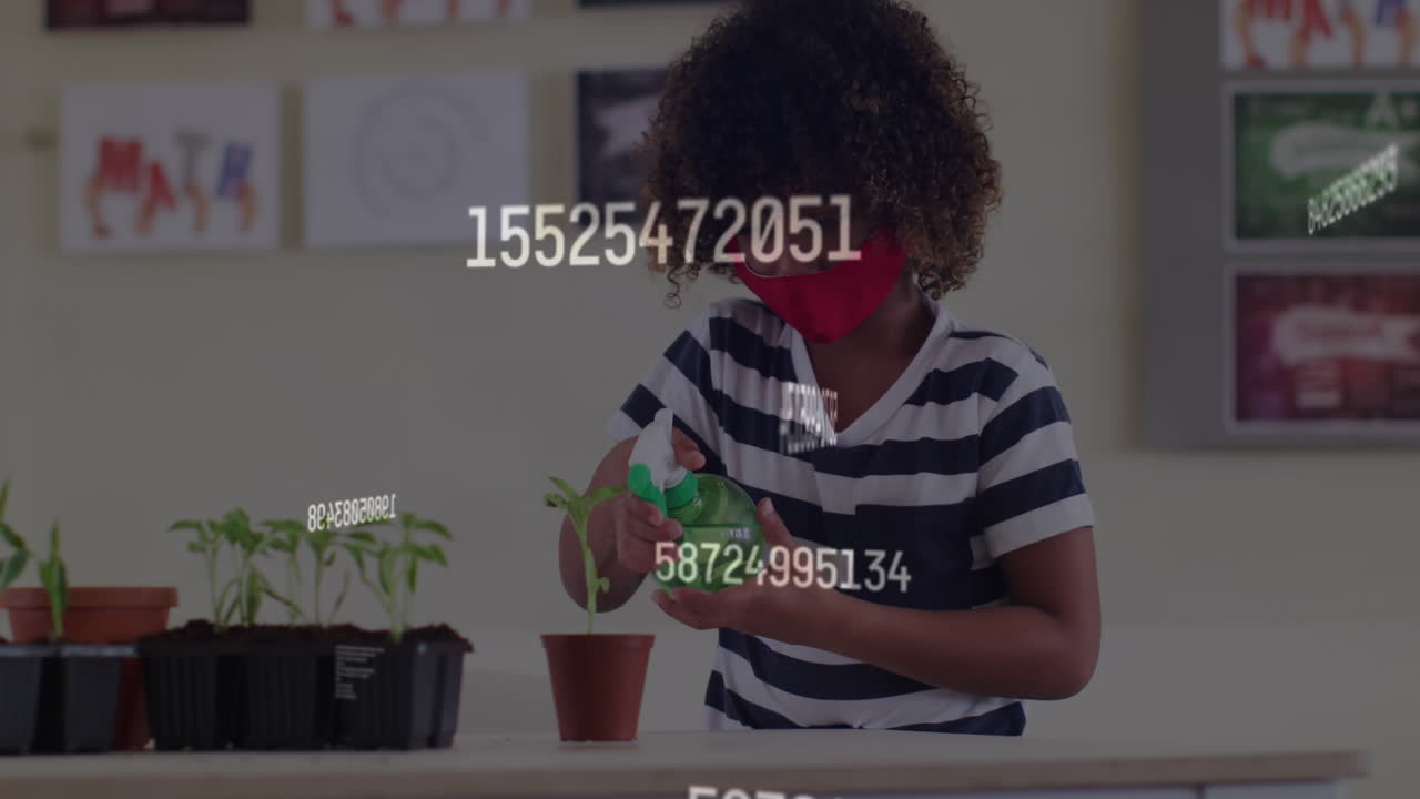 Animation of rising numbers and schoolchild in class wearing face mask watering plant