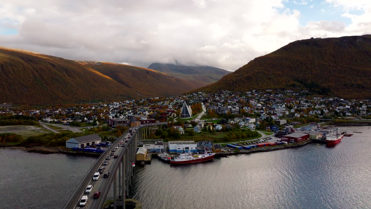 Aerial view of Arctic Cathedral and traffic on Tromso Bridge. Autumn season. Norway coastal