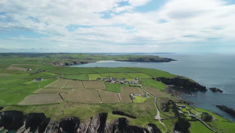 Calm-sunny-day-in-West-Cork,-rugged-coastal-line-at-the-Galley-Head-peninsula,-an-aerial-view