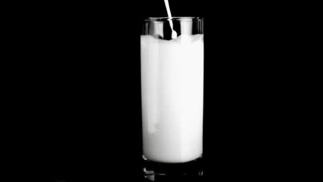 milk filling a glass in super slow motion