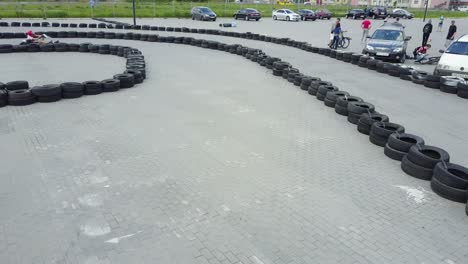 drivers in karts participate in kart race. vinnitsa, ukraine - may 2017: europe day, men drive karting car on outdoor track