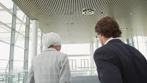 young business people on an escalator in a modern building