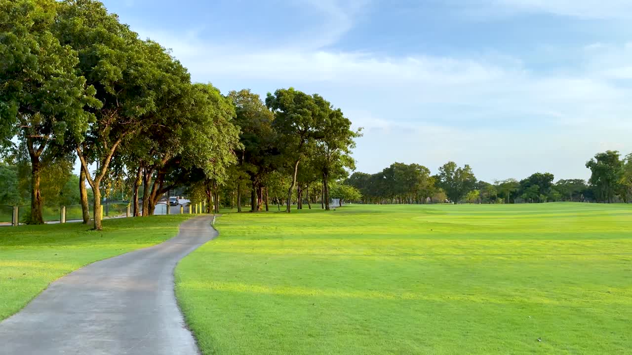 Peaceful golf course pathway with lush greenery