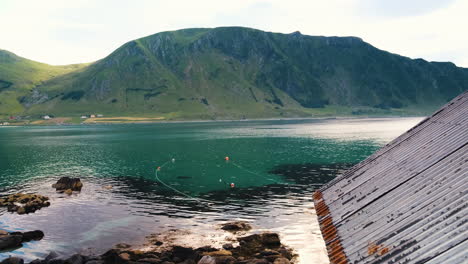 Turquoise-Waters-Of-Refviksanden-Beach-In-Maloy,-Vagsoy-Island,-Norway-With-Majestic-Mountain-In-Background