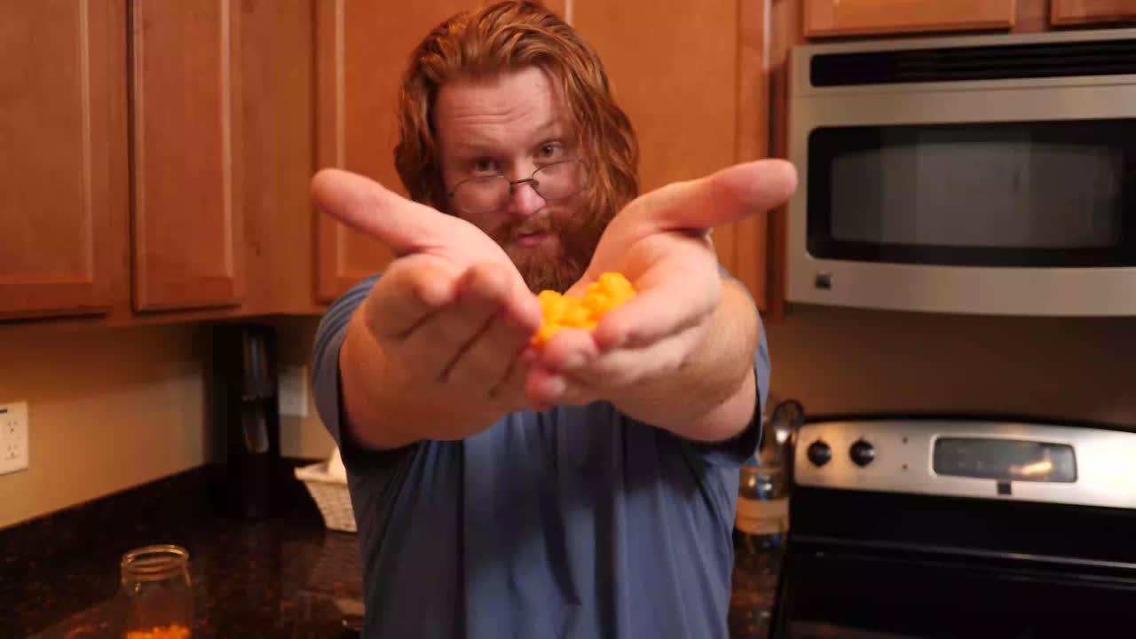 Red hair hands holding whey protein puff chips.