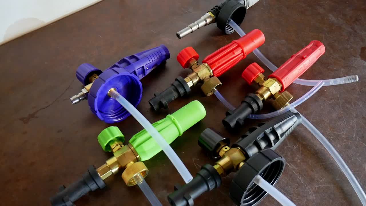 Panning shot are verious snow foam lances in different colours in a brown worktop