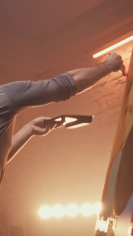 artist painting abstract artwork in studio